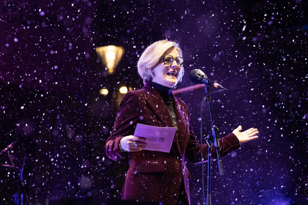 Nainen puhuu lavalla.